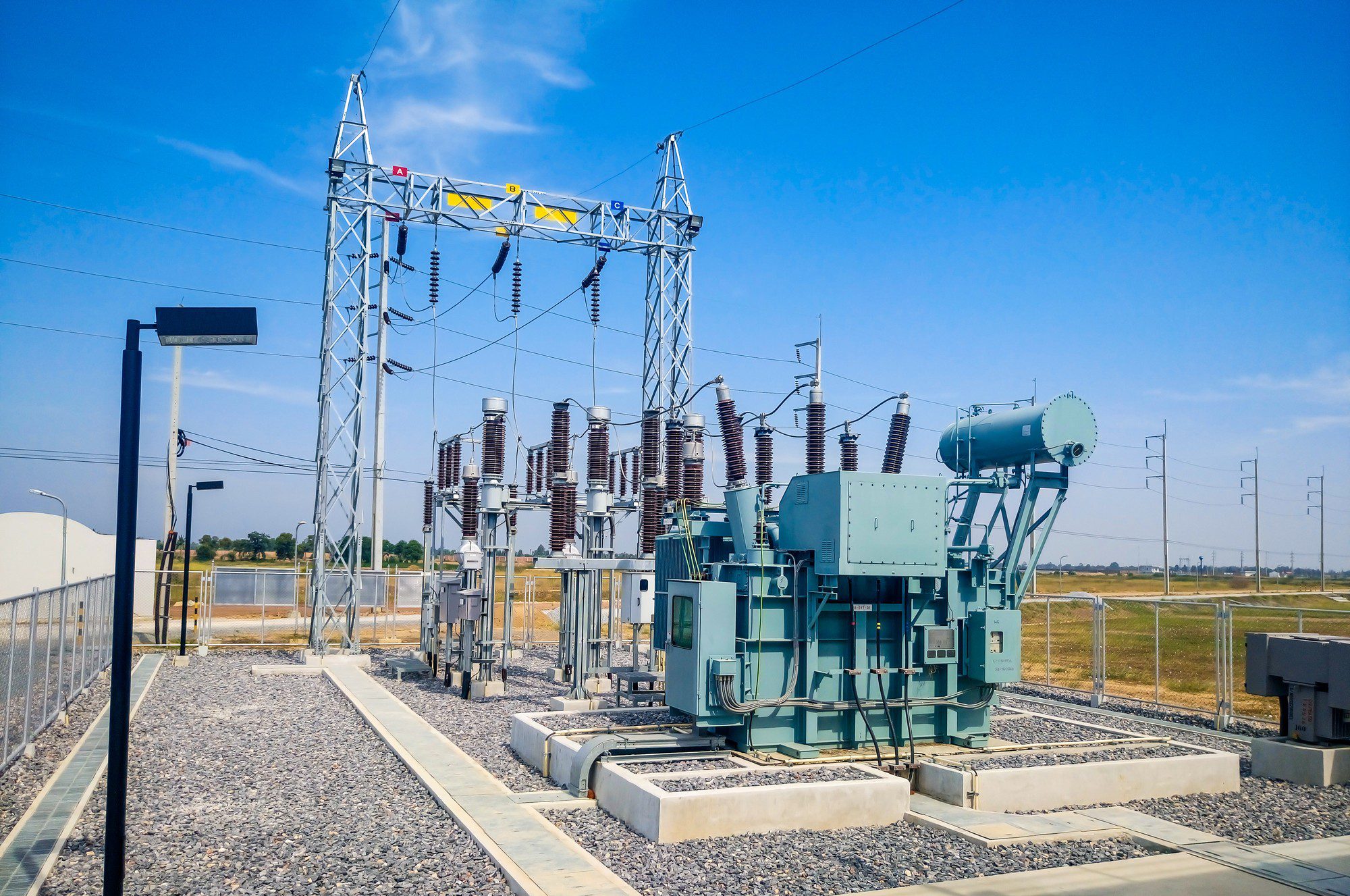 Electrical substation under clear blue sky.